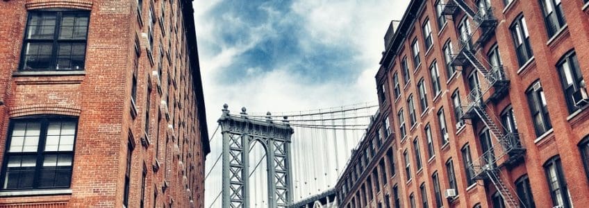 bridge seen between two brick buildings