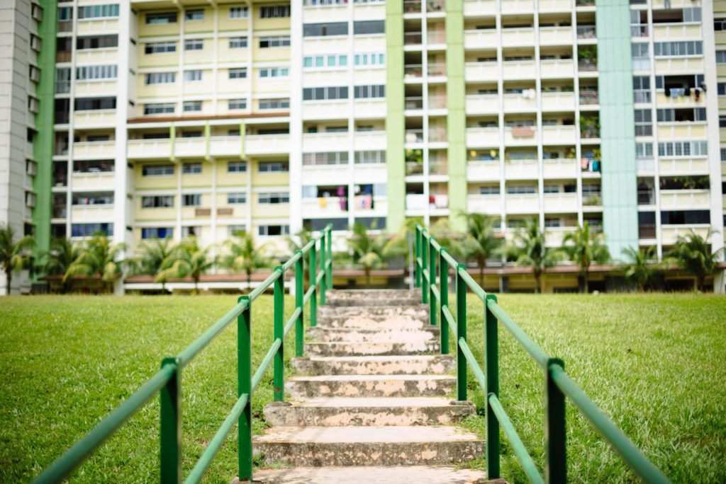 steps and green railings going up to residential buildings