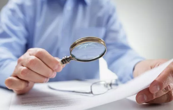 businessman with magnifying glass reading