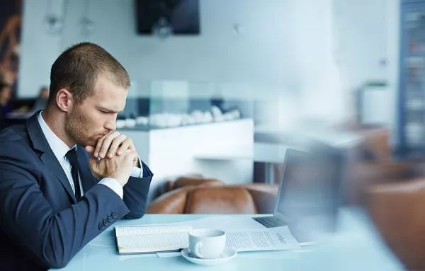 businessman doubts before signing paper