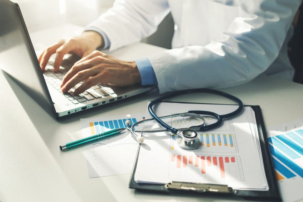 doctor working with medical statistics and financial reports